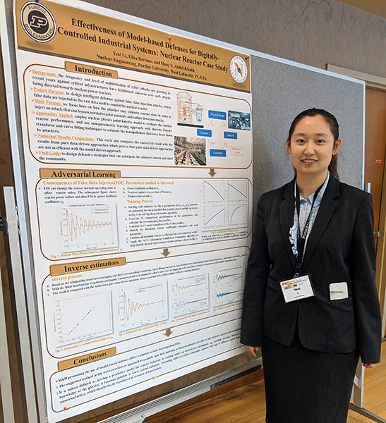 Yeni Li standing next to her winning poster